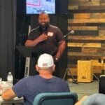 Man praying during prayer circle at Harvest Community Church